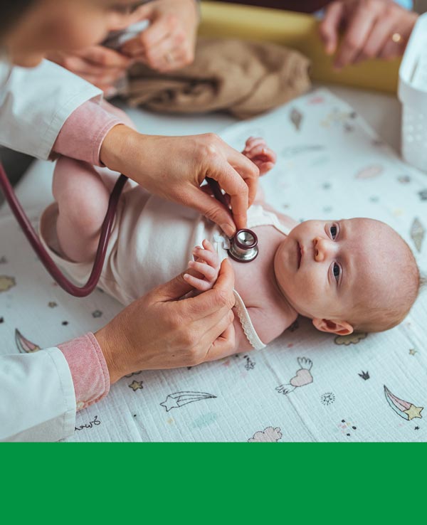 A healthcare professional examines an infant using a stethoscope, with gentle hands and attentive expressions present in a soft, comforting environment.
