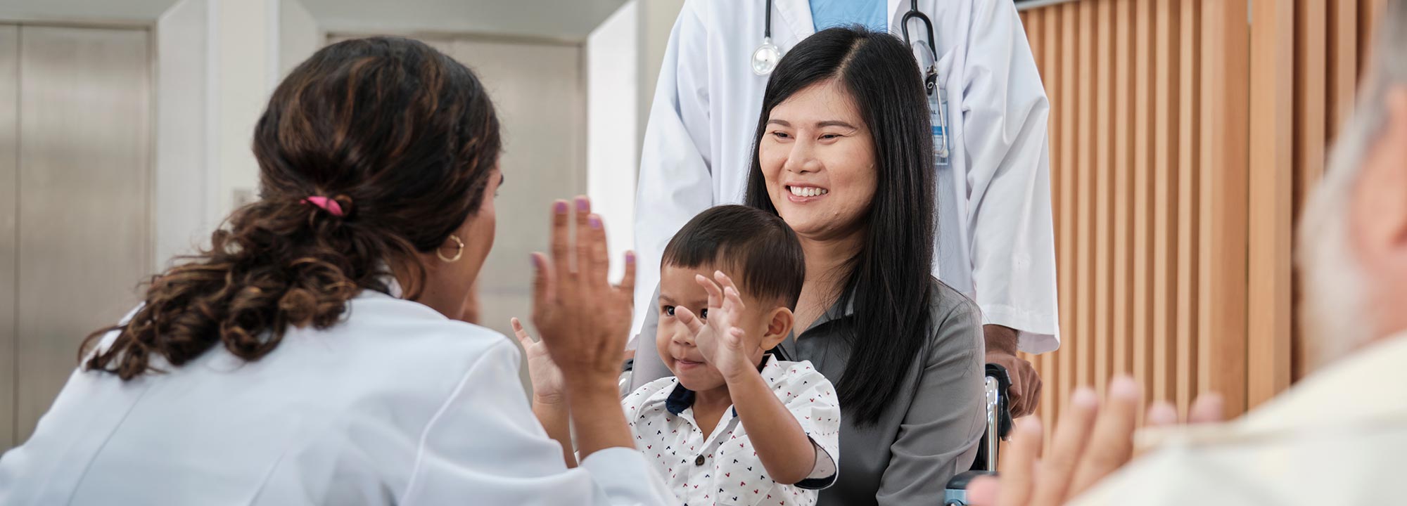 mom with baby and pediatrician bend, pediatric specialized support