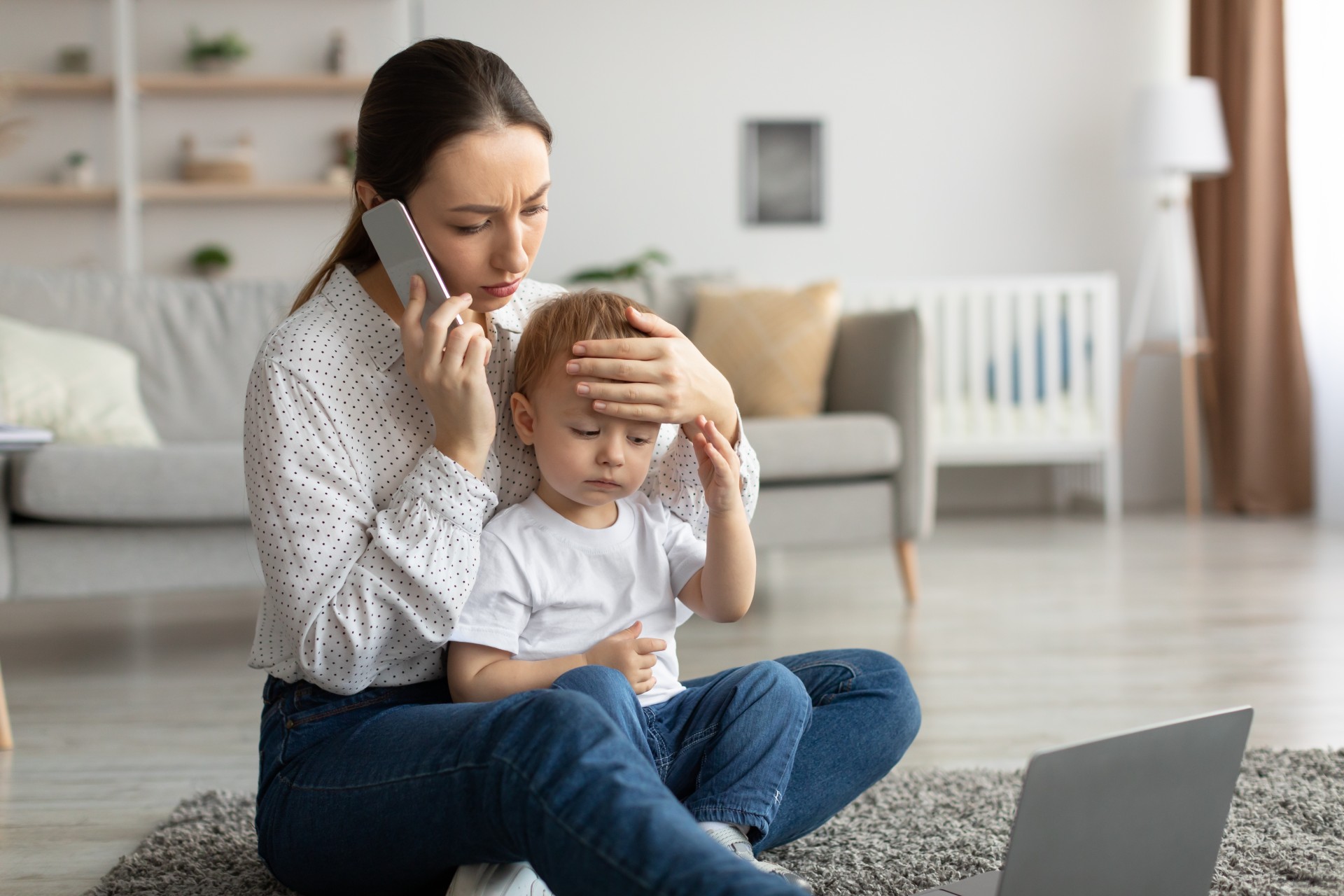 A mother checks her child's forehead for a fever.