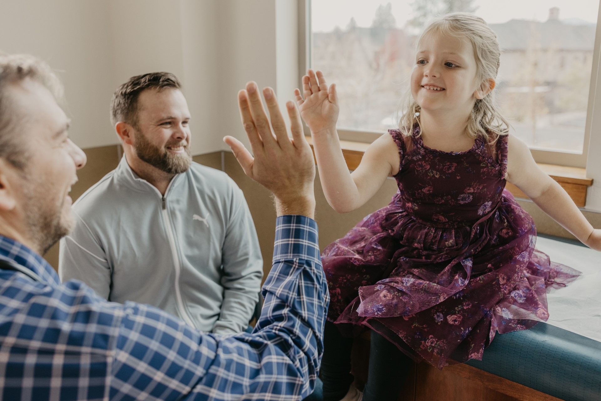 Pediatrician smiling and high fiving the patient.